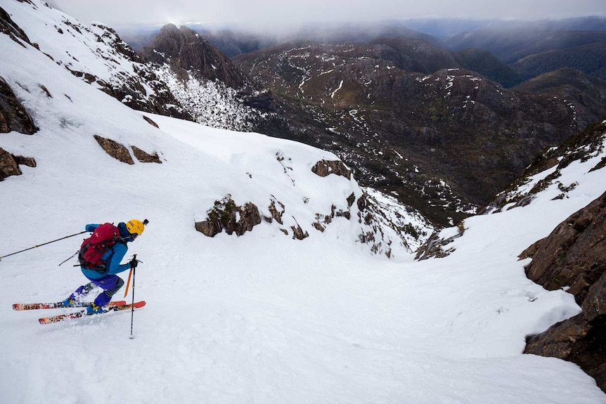 Skier takes off on Cradle Mountain