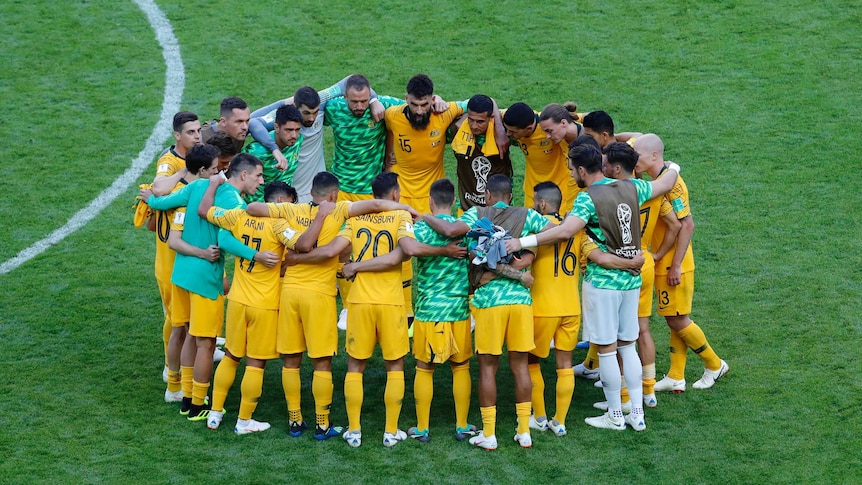 Australia's players huddle up after the loss to France
