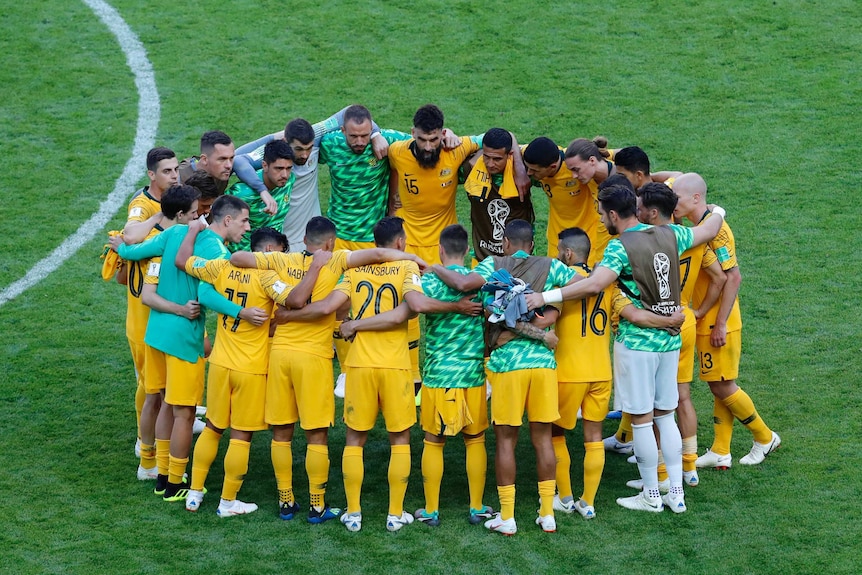 Australia's players huddle up after the loss to France