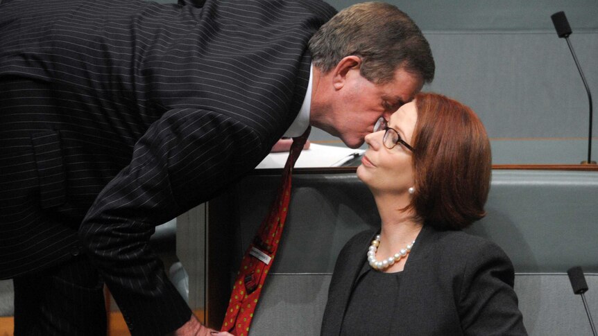 Julia Gillard receives a kiss from Peter Slipper.