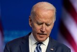 President-elect Joe Biden listens to a question from a reporter