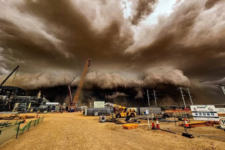A huge storm looms over a mining town.