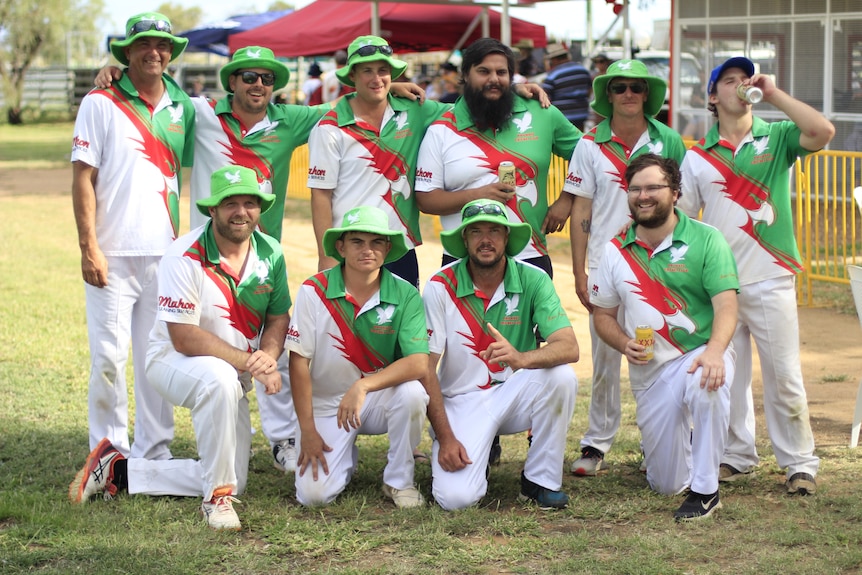 A cricket team celebrating while drinking beer 