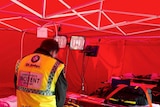 A St John Ambulance officer prepares the on-site emergency facility.