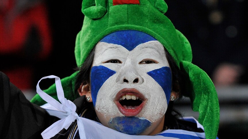 An enthusiastic Scottish Supporter sings the National Anthem before the start of the Scotland v Georgia RWC match