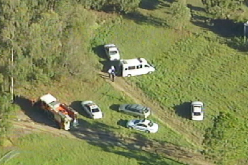 Aerial image of Queensland police and emergency services at the scene of a double murder.