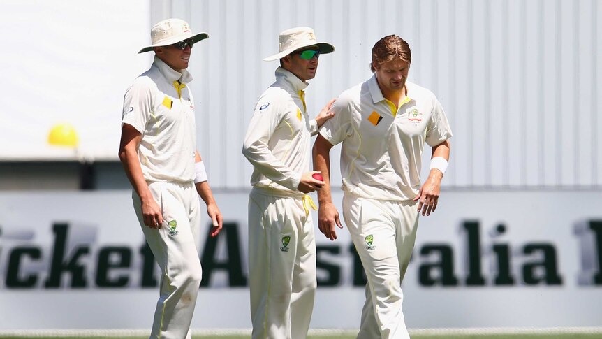 Shane Watson in consoled by Michael Clarke after injuring groin