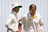 Shane Watson in consoled by Michael Clarke after injuring groin
