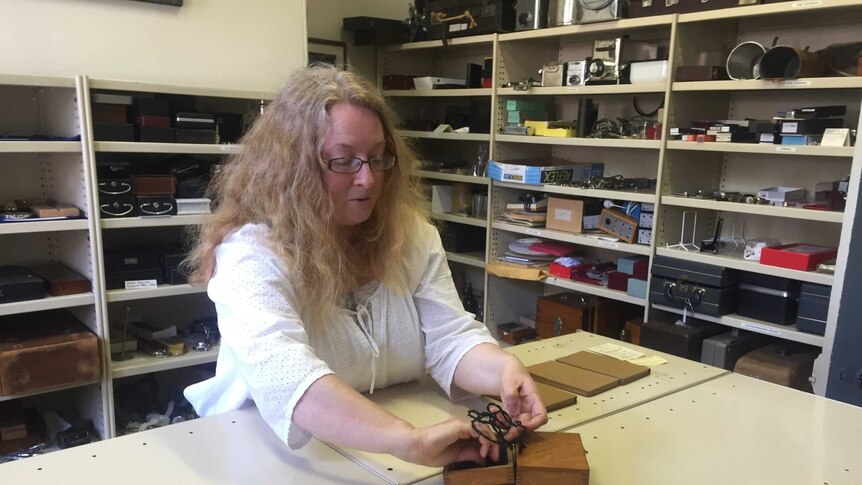 Curator Liz Bondfield looks at antique medical equipment.