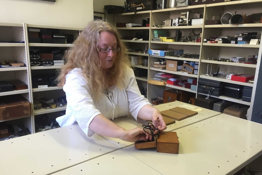 Curator Liz Bondfield looks at antique medical equipment.