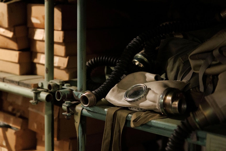 Gas mask lies on shelf of a Cold War bunker.