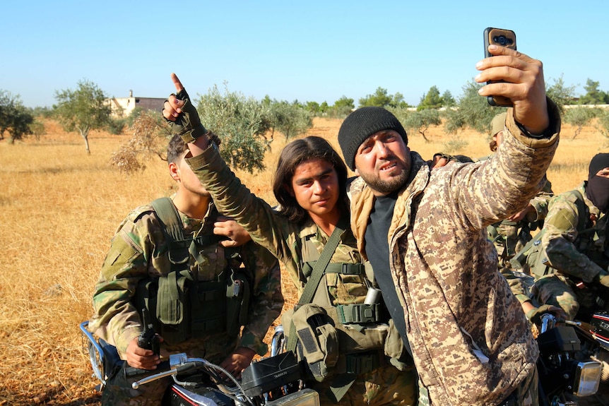 Rebel fighters take a selfie