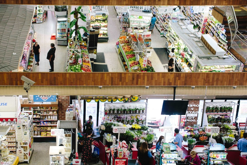 Wide shot of Piedimontes supermarket including a reflection of the aisles in a mirror.