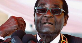 Robert Mugabe speaks into microphones.