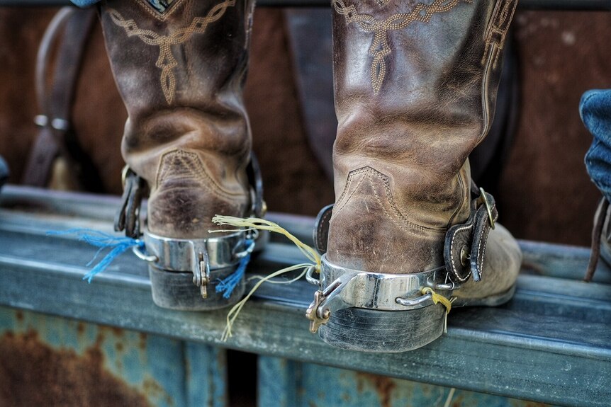 A close up shot of a rider's boots at Fitzroy Crossing Rodeo.