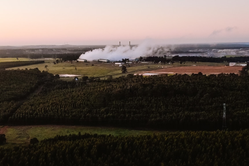 Aerial shot at dawn looking down over misty coal-fired power station