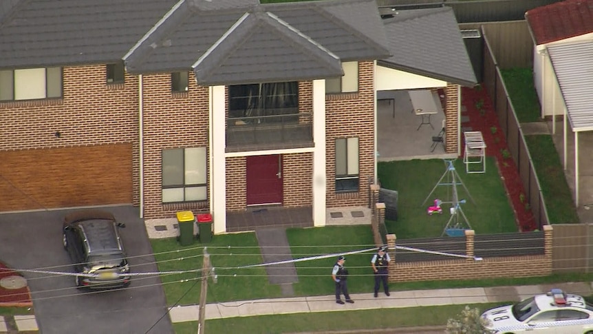 police stand at the front of house