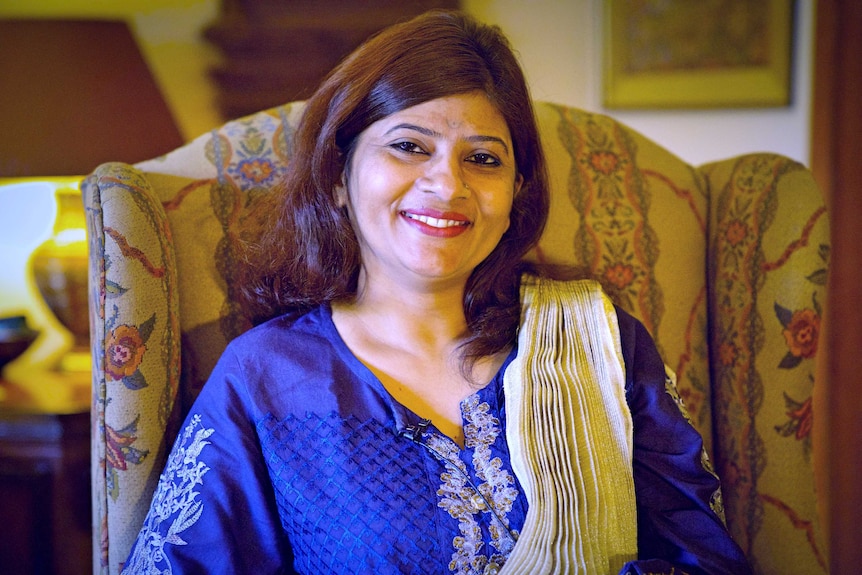 Krishna Kumari sits in her living room