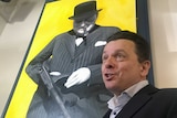 Nick Xenonophon points to a portrait of former British PM Winston Churchill.