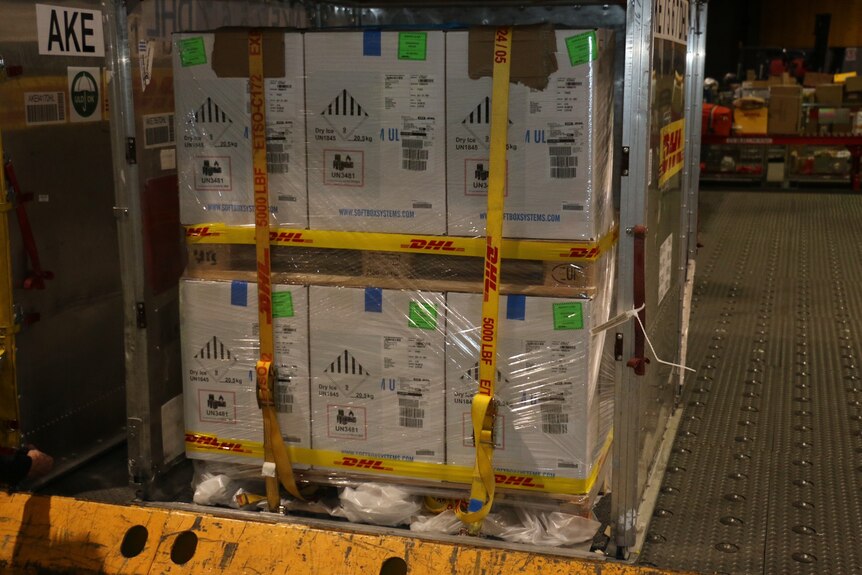 A crate of boxes at an airport.