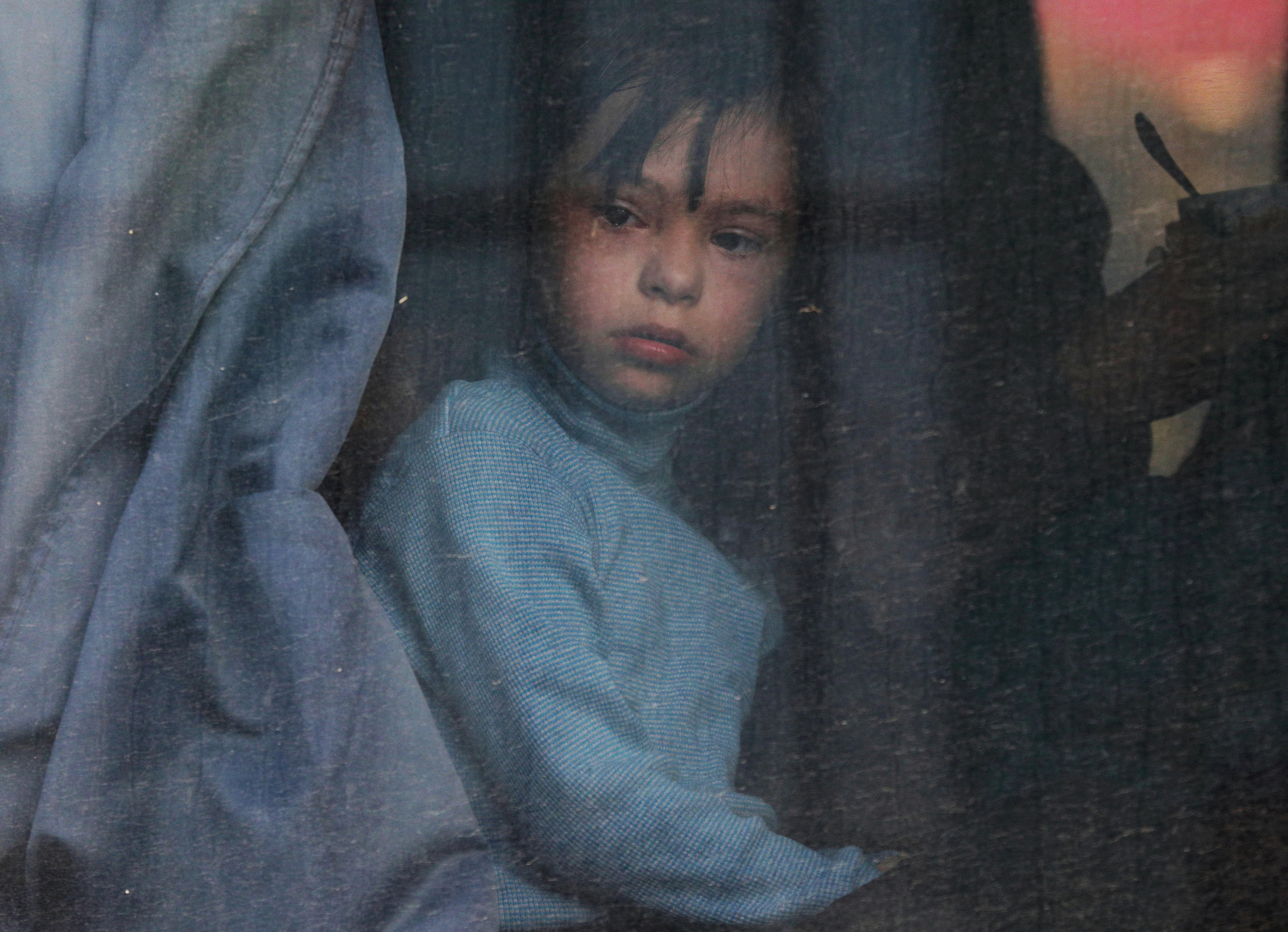 A child looks out of a bus window as civilians evacuated from the Russian-controlled Kherson region of Ukraine