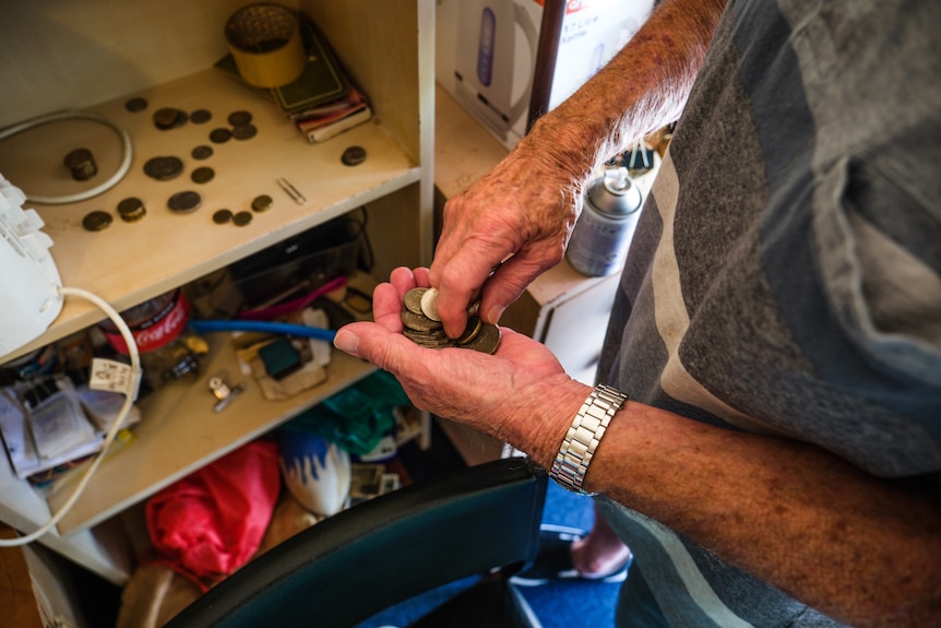 A man holding coins