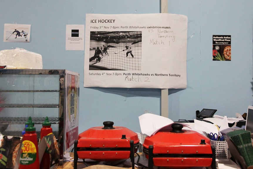 A paper sign advertising Friday and Saturday night's games behind the ice rink counter.