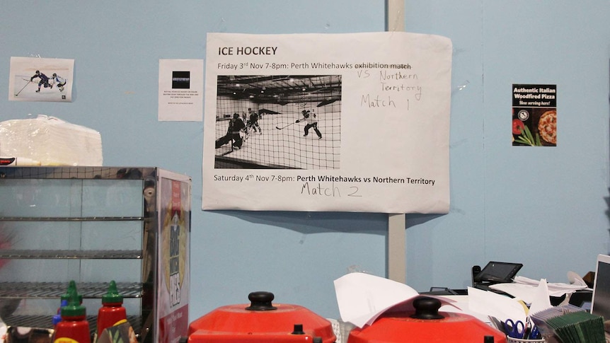 A paper sign advertising Friday and Saturday night's games behind the ice rink counter.