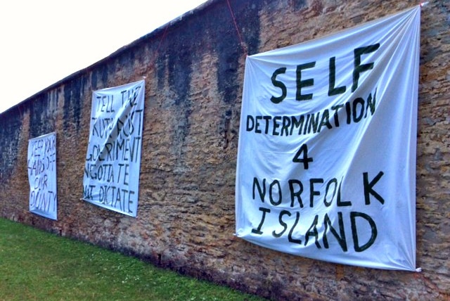 Norfolk Island protest signs on wall