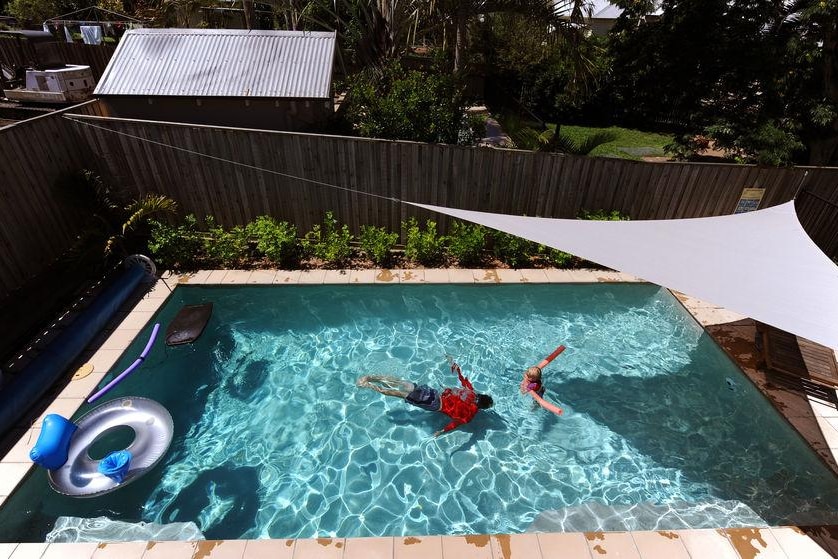 People swimming in a pool.