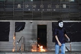A protester throws molotov cocktail to the entrance of MTR station during a protest in Hong Kong.