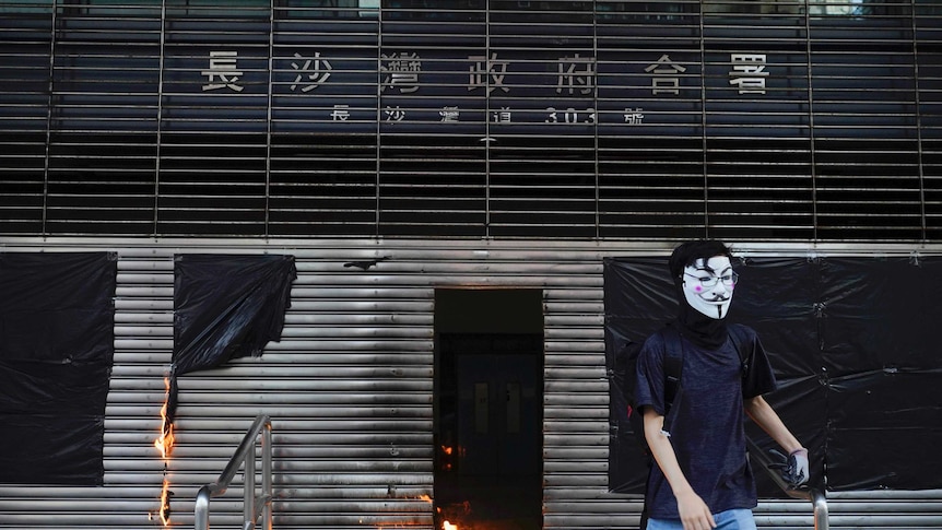 A protester throws molotov cocktail to the entrance of MTR station during a protest in Hong Kong.