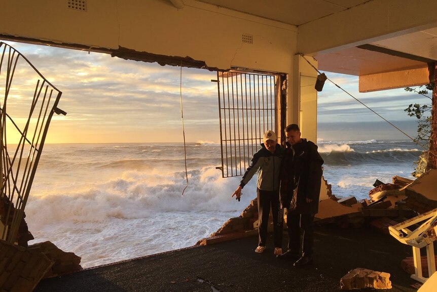 Local MP Matt Thistlethwaite inside the surf club where the wall has completely collapsed.