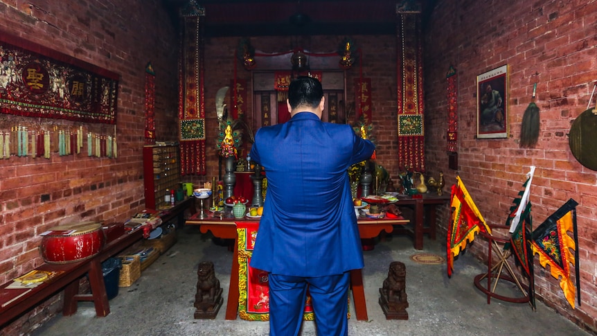 Bendigo surgeon Manny Cao at the main altar credits the temple with bringing him good fortune.