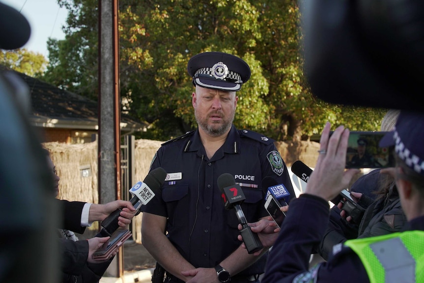 Detective chief inspector Scott Fitzgerald standing up speaking to journalists