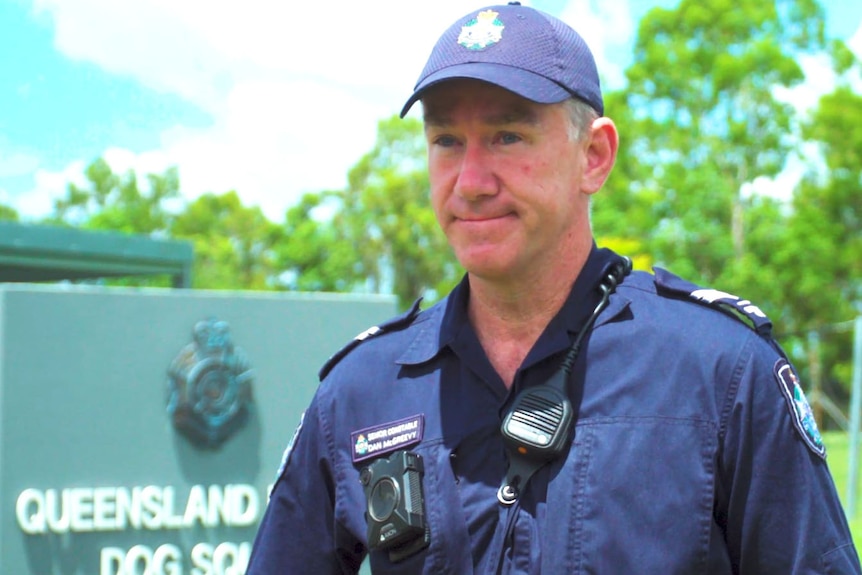 Queensland police Senior Constable Daniel McGreevy stands outside.