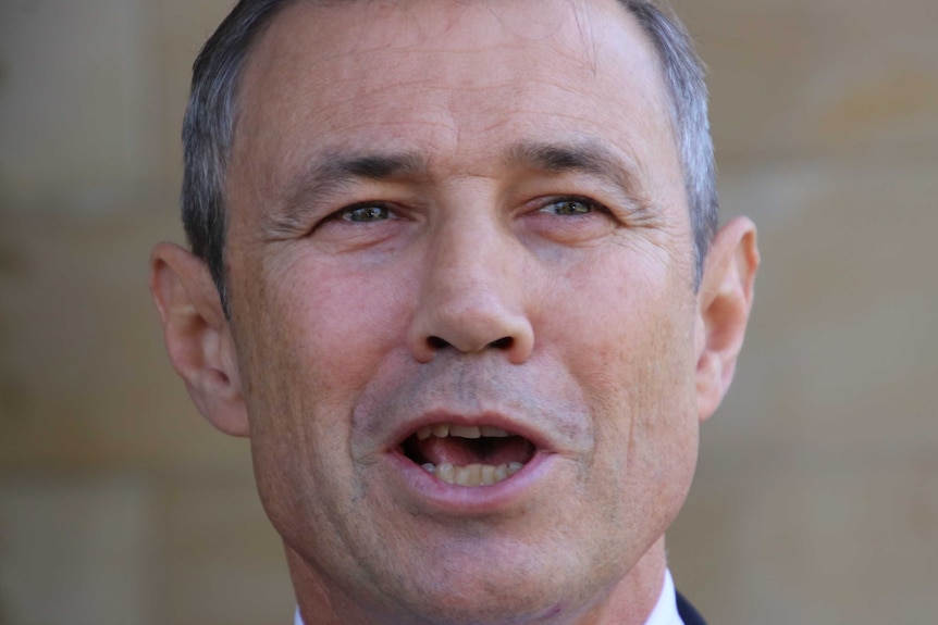 The WA Health Minister Roger Cook stands outside the WA Parliament.