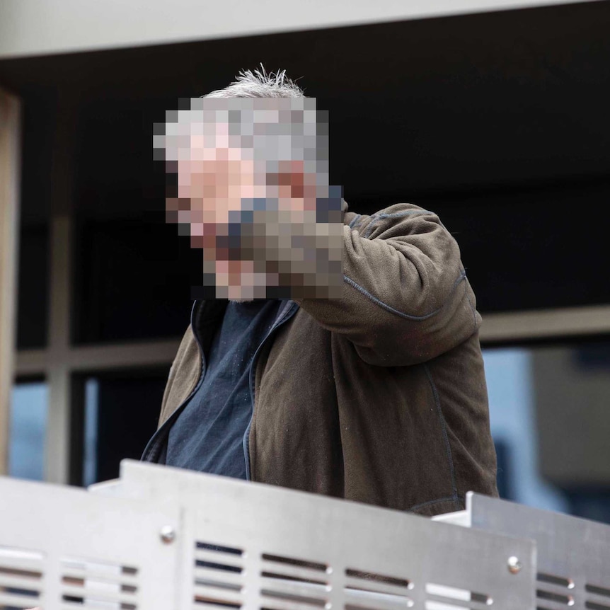 A pixelated photograph of a man.