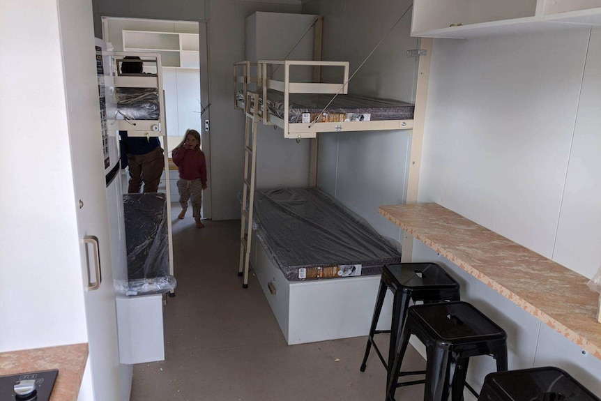 The family taking a look inside their new pod home.