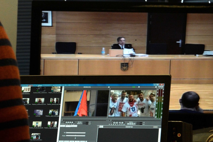 A picture of the accused is seen on screen in the courtroom.