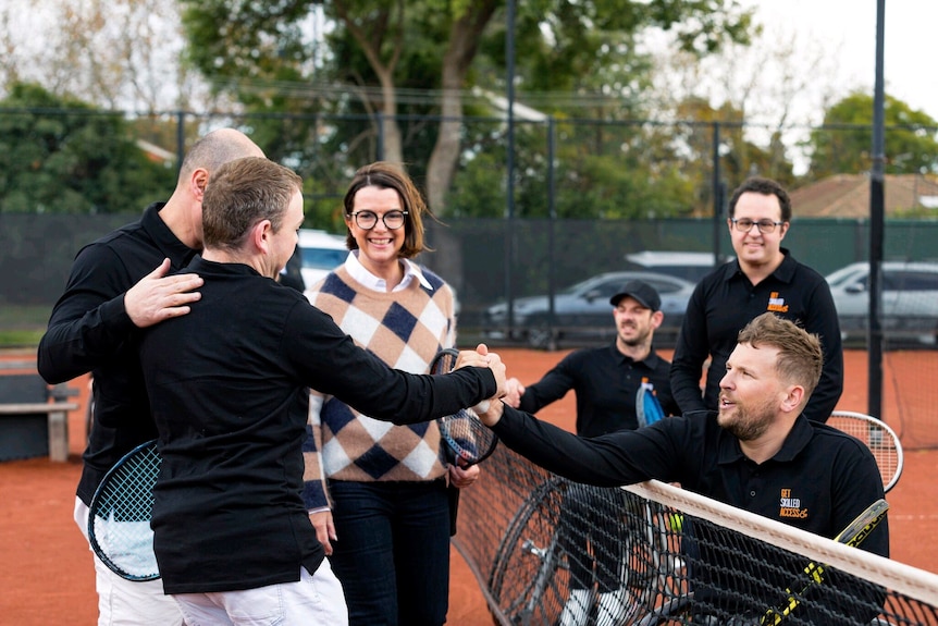 Hayden Walsh shakes hands with tennis star Dylan Alcott