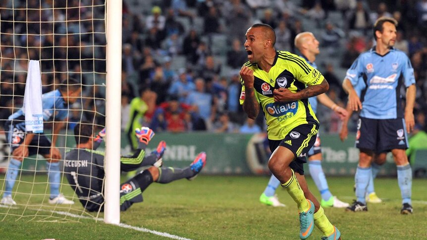 Melbourne Victory's Archie Thompson scores the side's equaliser against Sydney FC in a 3-2 win.