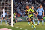 Melbourne Victory's Archie Thompson scores the side's equaliser against Sydney FC in a 3-2 win.