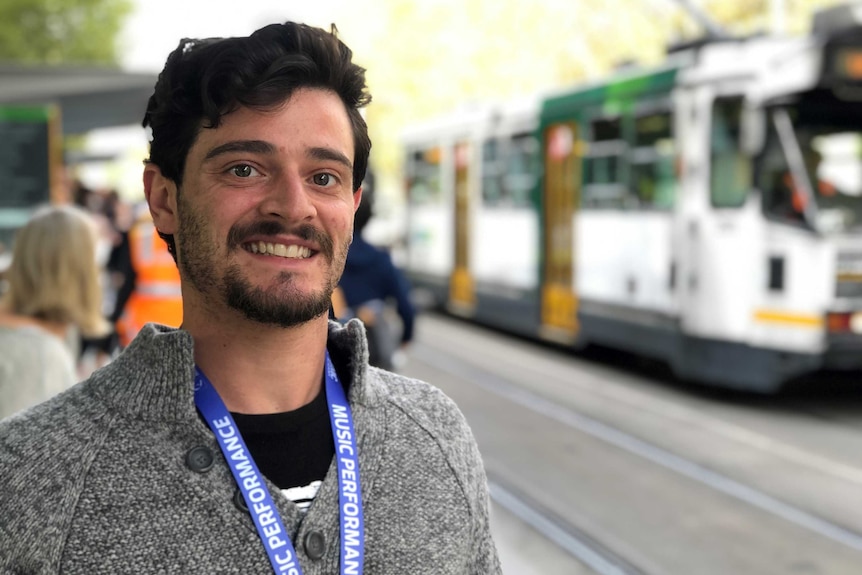 A man waits for a tram.