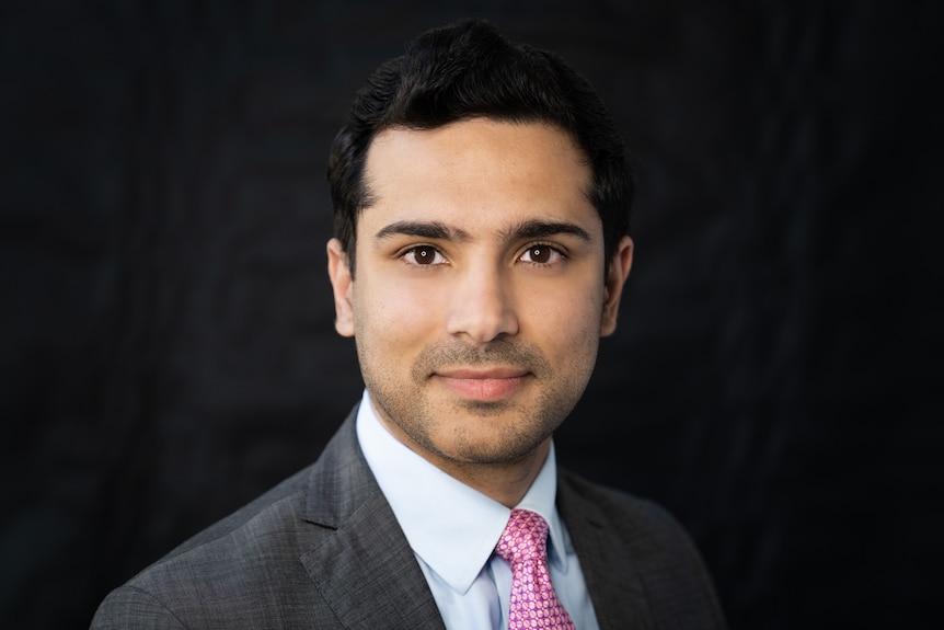 Mohammad Al-Khafaji wearing a nice suit and pink tie, smiling slightly in a businesslike headshot.
