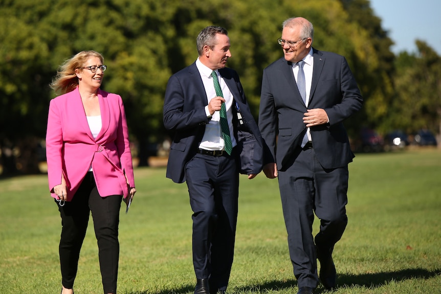 A wide shot of Rita Saffioti, Mark McGowan and Scott Morrison walking outdoors and smiling.