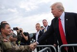 Donald Trump shakes hands with members of the military as he arrives at Raleigh County Memorial Airport in Beaver, West Virginia