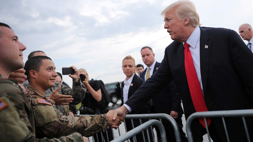 Donald Trump shakes hands with members of the military as he arrives at Raleigh County Memorial Airport in Beaver, West Virginia