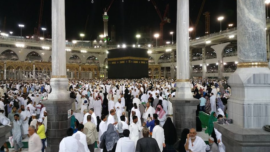 Crowd inside the Grand Mosque in Mecca with a black cube in the middle