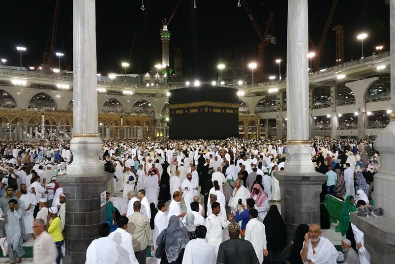 Crowd inside the Grand Mosque in Mecca with a black cube in the middle